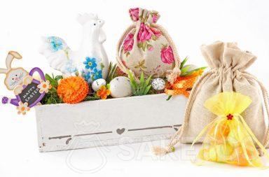 A colourful Easter composition created from cloth bags and a rectangular flowerpot with Easter eggs