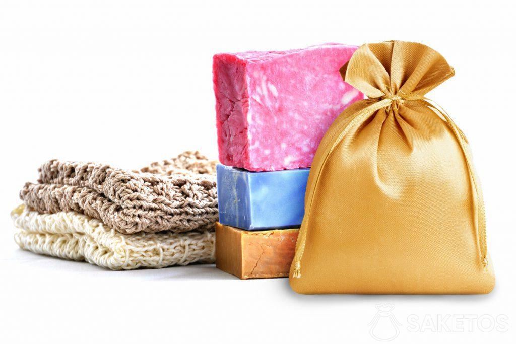 Golden satin bag in the background with colorful soaps.