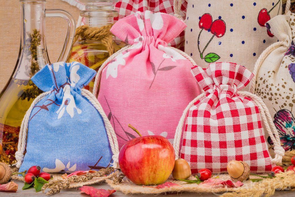 Linen bags with colourful prints for home decorations. An organza bag makes an elegant packaging option for a candle