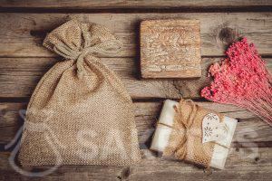 White natural soap can be decorated and wrapped as a gift in a jute bag.