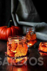 An autumn table candle holder made of leaves and a jar