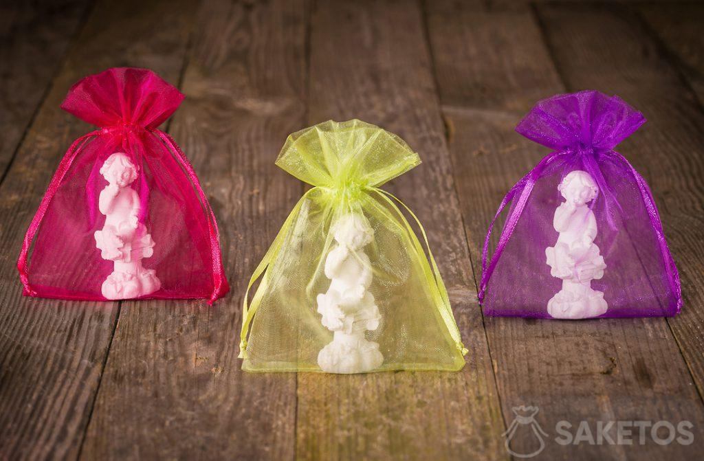 Angel figurines packed in colorful organza bags for thanks to wedding guests.