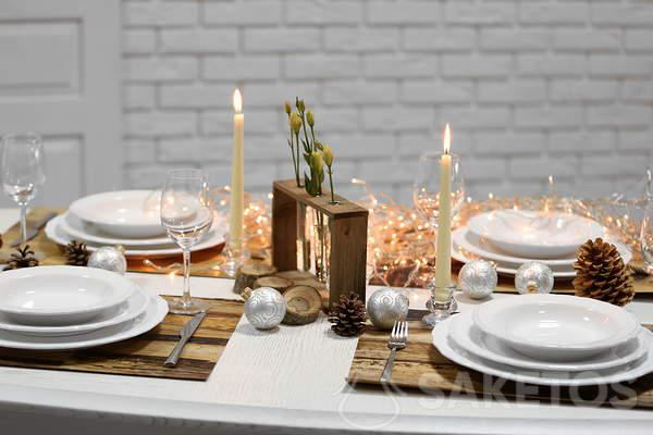 Christmas table with a white tablecloth - white tablecloth and wooden accessories