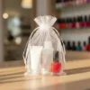Organza bag 15x20 cm with contents in the form of nail polishes and cosmetic accessories.