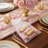Organza bags filled with sweets on an elegant wedding table.