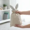 Linen bags with a cute plush bunny inside.