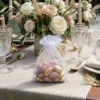 Organza gift bag with pink almonds - wedding favor for guests.