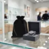 Velvet pouch in black protecting a premium watch in a jewellery boutique.