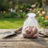 White organza pouch for storing flower bulbs in the garden.