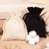 Set of eco cotton bags in black and natural color with raw cotton.