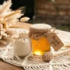 Cotton pouch by a honey jar as a natural wedding favor for guests.