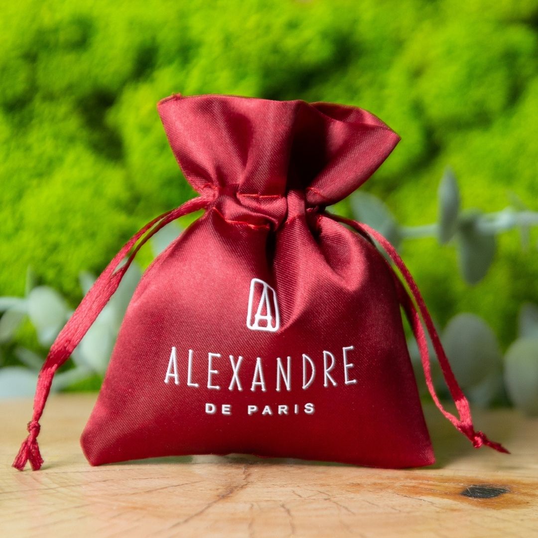 Red satin pouch with Alexandre de Paris logo and drawstring closure.