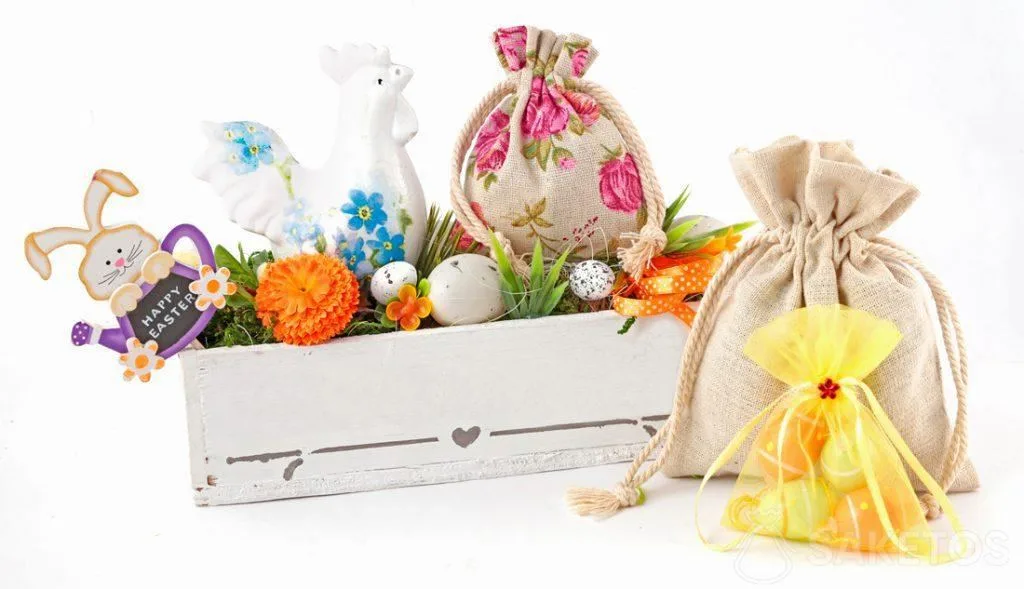 A colourful Easter composition created from cloth bags and a rectangular flowerpot with Easter eggs