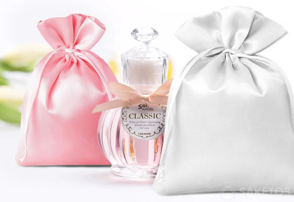 Satin pouches in pink and silver and a decorative perfume bottle