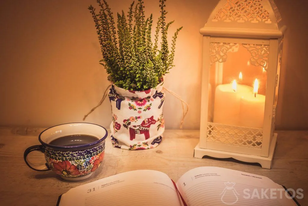 1.A table with a decorative lantern and a linen bag used as a pot cover