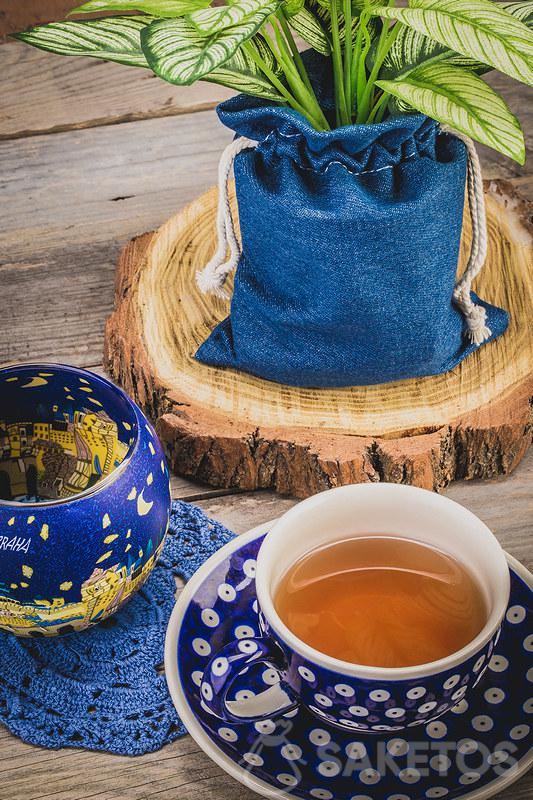 4.A ceramic cup with tea and a denim bag for a flowerpot