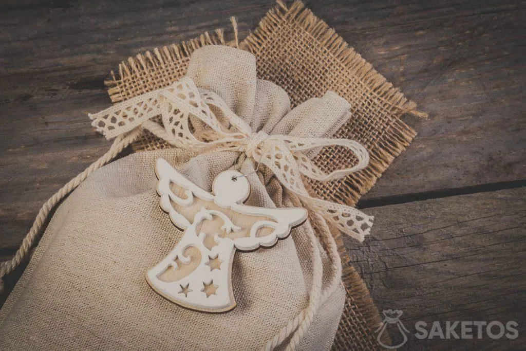 Linen bag tied with a decorative ribbon bow with a decorative pendant