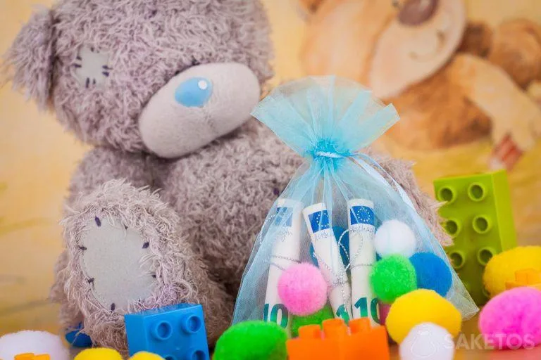 A teddy bear holding a money bag for a child