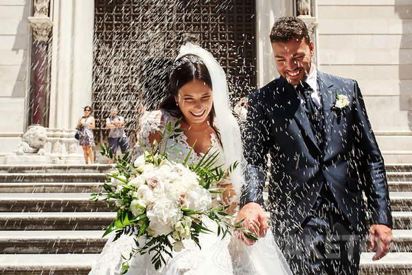 Sprinkling with rice to welcome the bride and groom.