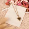 Cotton pouches as packaging for necklace with heart pendant - elegant gift idea