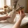 Linen bags in hands while packing dried lavender for gift sachets