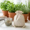 Linen bags next to potted herbs and glass jar - eco storage and gift packaging
