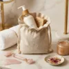 Linen bags with cosmetics and towel on a marble bathroom shelf
