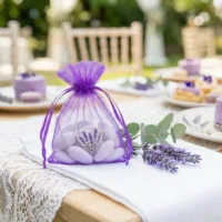 Organza bags with lavender print as decorative gift packaging on a garden table